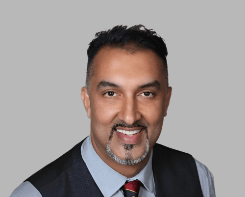 Faculty member standing in clinical scrubs